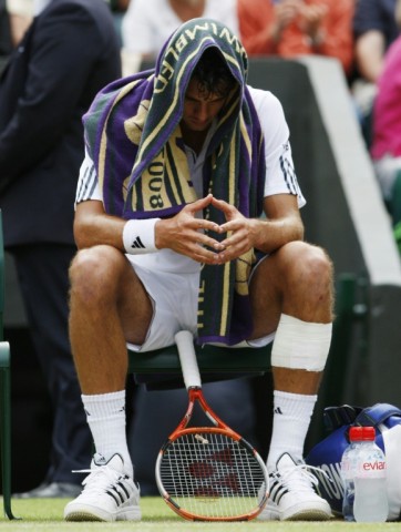 Shock triumph: Mario Ancic sits on his chair after his 2002 win over Federer 