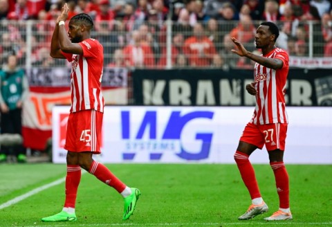 Union Berlin's American forward Jordan Siebatcheu (L) celebrates his goal