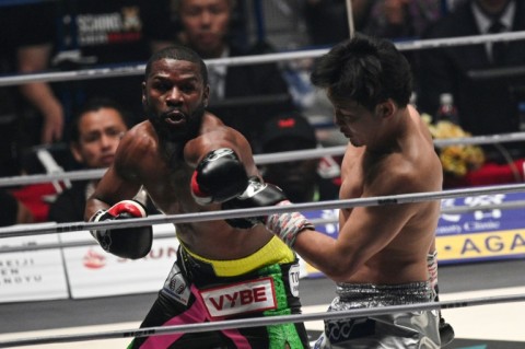 Floyd Mayweather (left) throws a punch at Japan's Mikuru Asakura during their exhibition fight in Saitama, Japan, on Sunday