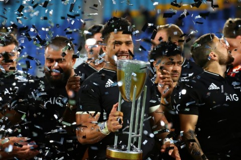 New Zealand's captain New Zealand's Ardie Savea celebrates with the trophy after the All Blacks won the Rugby Championship in 2021. This year's title will go to the wire on Saturday