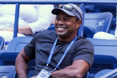 Tiger Woods, shown watching the US Open tennis tournament, is offering advice from afar to US Presidents Cup captain Davis Love as his recovery from severe leg injuries will not allow him to attend at Quail Hollow