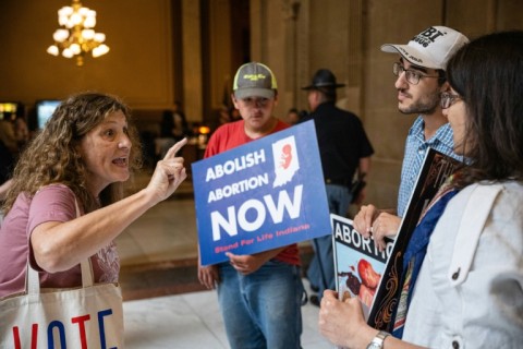 An abortion rights protester shouts at a group of anti-abortion activists in Indianapolis on July 25, 2022 