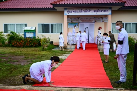A red carpet installed around the nursery by officials before the royal wreath was laid was swiftly removed