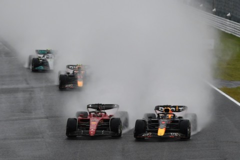Red Bull Racing's Dutch driver Max Verstappen (R) and Ferrari's Monegasque driver Charles Leclerc (C) take the first turn at the start of the Formula One Japanese Grand Prix at Suzuka, Mie prefecture on October 9, 2022.