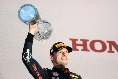 Red Bull Racing's Dutch driver Max Verstappen poses on the podium with the trophy following his victory at the Formula One Japanese Grand Prix at Suzuka, Mie prefecture on October 9, 2022.