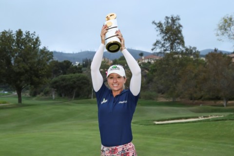 England's Jodi Ewart Shadoff hoists the champion's trophy after capturing her first LPGA title at the Mediheal Championship