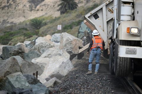 Every day tons of rocks are dumped to reinforce the seawall