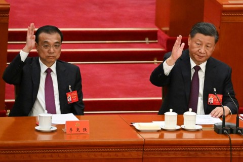 President Xi Jinping (R) was set to emerge from the event as party leader for an unprecedented third term