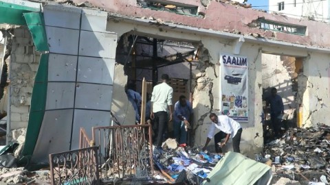 People clear rubble day after twin blasts rock Somali capital