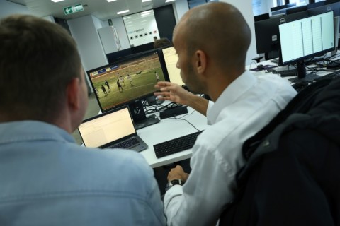 Tom Mace (left) with an analsyst responding to alerts on the company's betting patterns detection system 