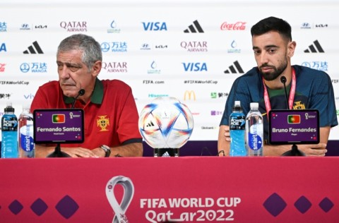 Portugal's coach Fernando Santos (L) and Portugal midfielder Bruno Fernandes hold a press conference