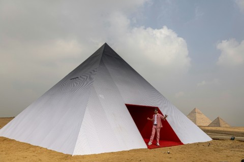 French photographer and street artist JR poses before his artwork "Inside Out Giza"