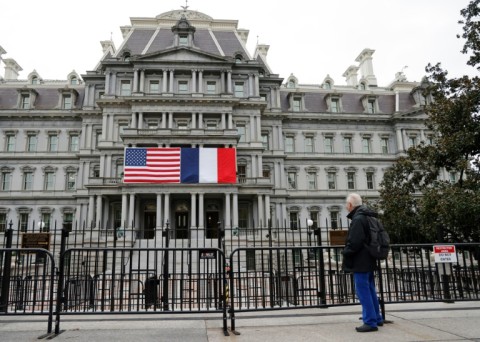 French and US flags adorn the Eisenhower Executive Office Building next to the White House for the state visit of French President Emmanuel Macron who arrives in Washington on November 29, 2022