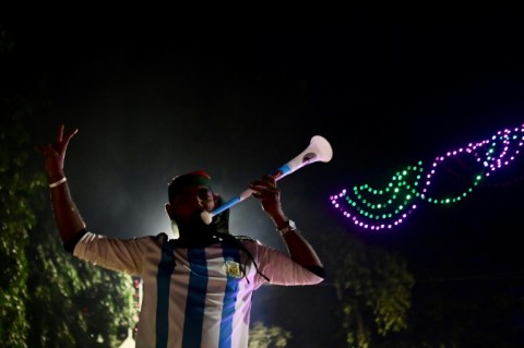 An Argentina fan in Dhaka blows a vuvuzela as he cheers on his favourite team