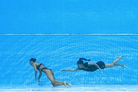 Safe and sound: Andrea Fuentes (right) swims to rescue Anita Alvarez 