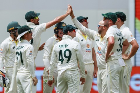 Australia's Nathan Lyon (3rd R) celebrates after taking the wicket of West Indies' Kraigg Brathwaite 
