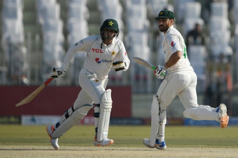 Pakistan's Salman Ali Agha (right) and teammate Zahid Mahmood run between wickets in Rawalpindi