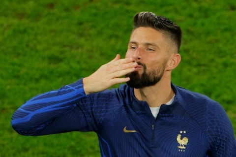 Sealed with a kiss: Olivier Giroud celebrates after a record-breaking performance in France's World Cup win over Poland 