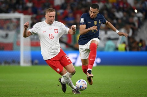 France forward Kylian Mbappe races away from Poland's Kami Glik during Les Bleus' last 16 victory
