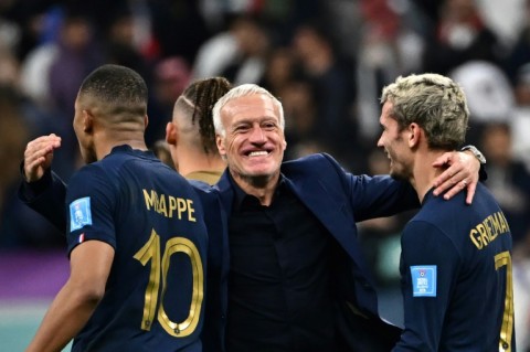 France coach Didier Deschamps celebrates with Kylian Mbappe and Antoine Griezmann after Saturday's World Cup quarter-final win over England