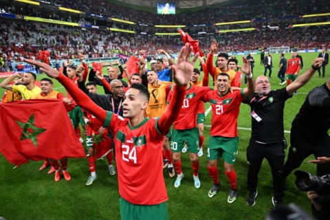Morocco players celebrate with their supporters after they beat Portugal in the World Cup quarter-finals