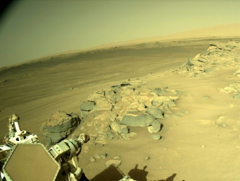 NASA's Perseverance rover looks out on the surface of Mars, where dust devils sweep across the arid surface