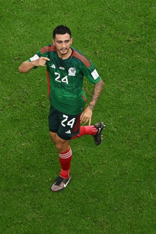Mexico's Luis Chavez celebrates scoring a long-range free-kick against Saudi Arabia during the group stage