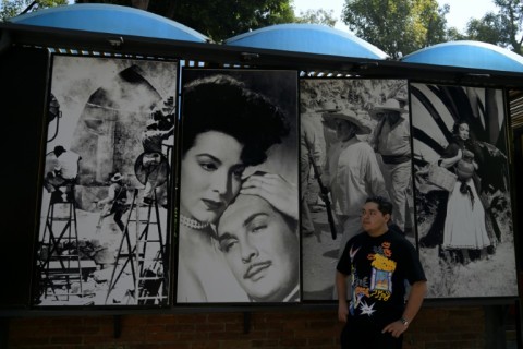 A man is seen next to photographs of actors from the golden age of Mexican cinema, at the Churubusco studios in Mexico City