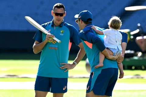 Seamer Scott Boland (L, with captain Pat Cummins) is assured of another game at the MCG, where he took an incredible 6-7 on debut against England a year ago