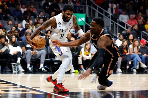 Brooklyn's Kyrie Irving drives against Atlanta's Aaron Holiday in the Nets' 108-107 NBA victory over the Hawks