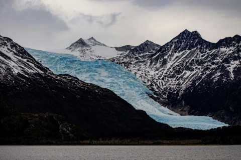A glacier stretches over the Darwin Mountain Range in the Magallanes region of southern Chile, seen in September 2022