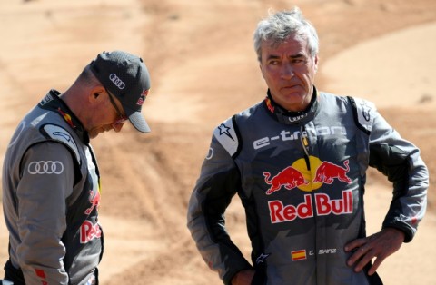 Audi's hybrid drivers Stephane Peterhansel of France (L) and Carlos Sainz of Spain after their respective crashes on stage six