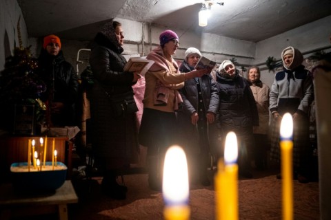 Worshippers attended an Orthodox Christmas mass in a basement shelter as artillery boomed outside and fighter jets flew overhead