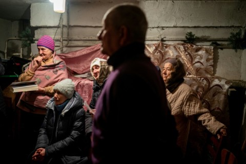 During a two-hour service, worshippers did their best to tune out the war