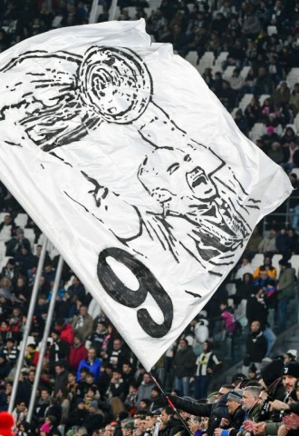 A flag depicts Gianluca Vialli holding aloft the Champions League trophy in 1996