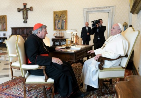 A Vatican Media photo shows Pope Francis talking with Australian Cardinal George Pell during a private audience at the Vatican in October 2020