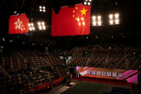 Flags of China (R) and Hong Kong hang above Hong Kong’s Queen Elizabeth Stadium