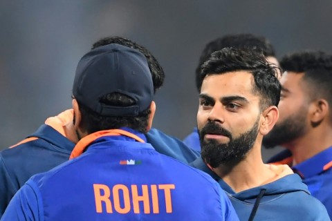 India's Virat Kohli (R) speaks with Rohit Sharma