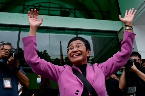 Nobel Prize winner Maria Ressa waves to supporters Wednesday after her acquittal on all four charges of tax evasion filed against her