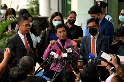 Maria Ressa, seen here outside a Manila court, won the 2021 Nobel Peace Prize with Russian journalist Dmitry Muratov