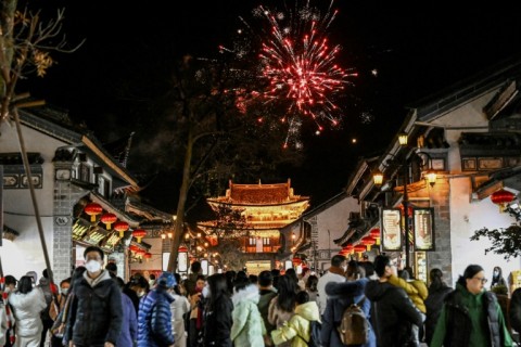 Watering holes and street food stalls in Dali's bustling old town are packed as the sounds of firecrackers punctuate the night