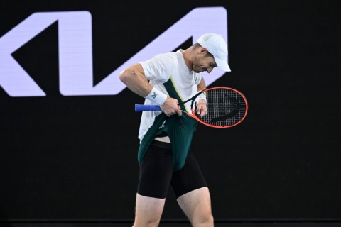 Britain's Andy Murray adjusts his shorts  against Australia's Thanasi Kokkinakis