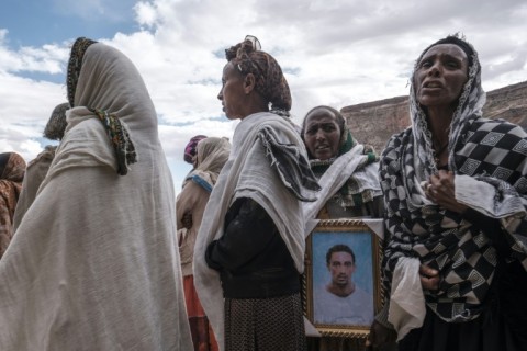 People mourn the victims of a massacre allegedly perpetrated by Eritrean soldiers in the village of Dengolat, north of Mekele, the capital of Tigray on February 26, 2021