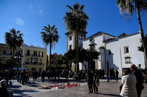 Flowers and candles mark the spot outside the church where verger Diego Valencia was killed