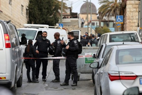 Israeli security forces stand guard near the site of an attack carried out on Saturday in Silwan, near Jerusalem's Old City