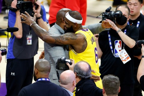 LeBron James, at center right, celebrates with retired Los Angeles Lakers legend Magic Johnson, center left, after James overtook Kareem Abdul-Jabbar to become the NBA's all-time leading scorer