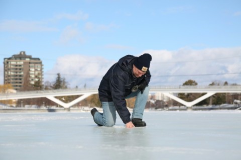Bruce Devine, senior manager facilities and programs at the National Capital Commission checks the ice condition on the Rideau Canal on February 8, 2023 in Ottawa, Canada 