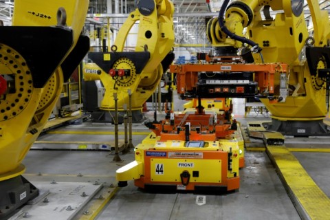 A robot lifts a battery for installation in a Ford F-150 Lightning in Dearborn, Michigan in September 2022 