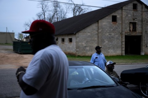 Kelvin Sims (L) talks with others outside the Dollar General in Plains, Georgia