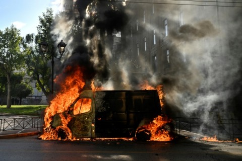 A van was set ablaze during protests in Athens over a train crash last week that killed 57 people